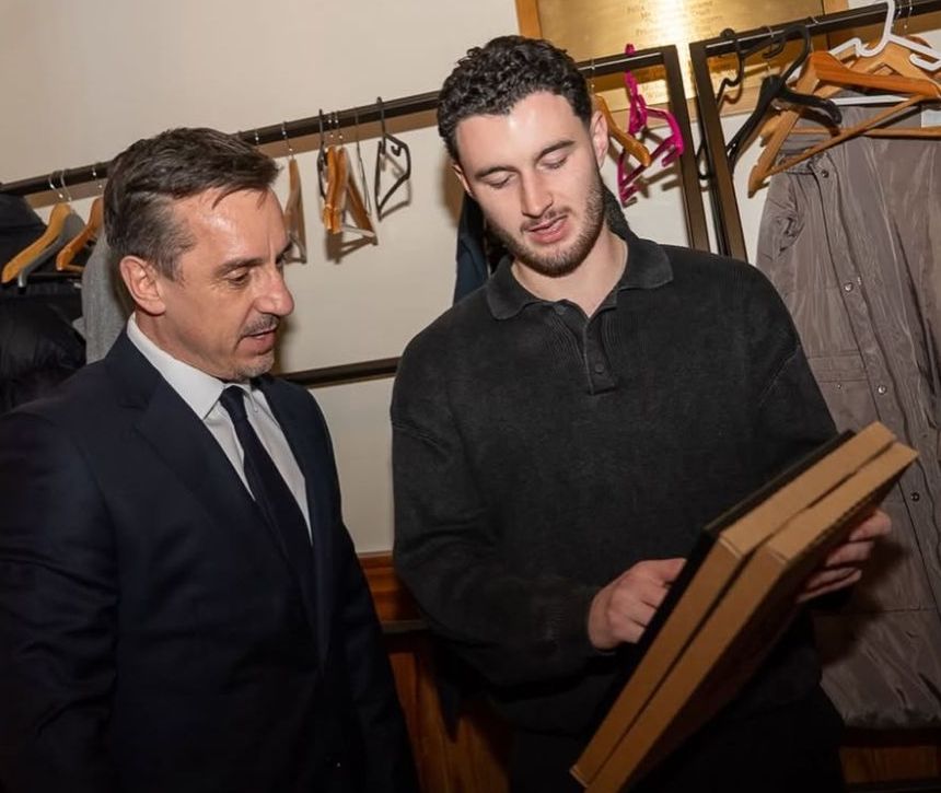 Rory showing Gary Neville a framed shirt
