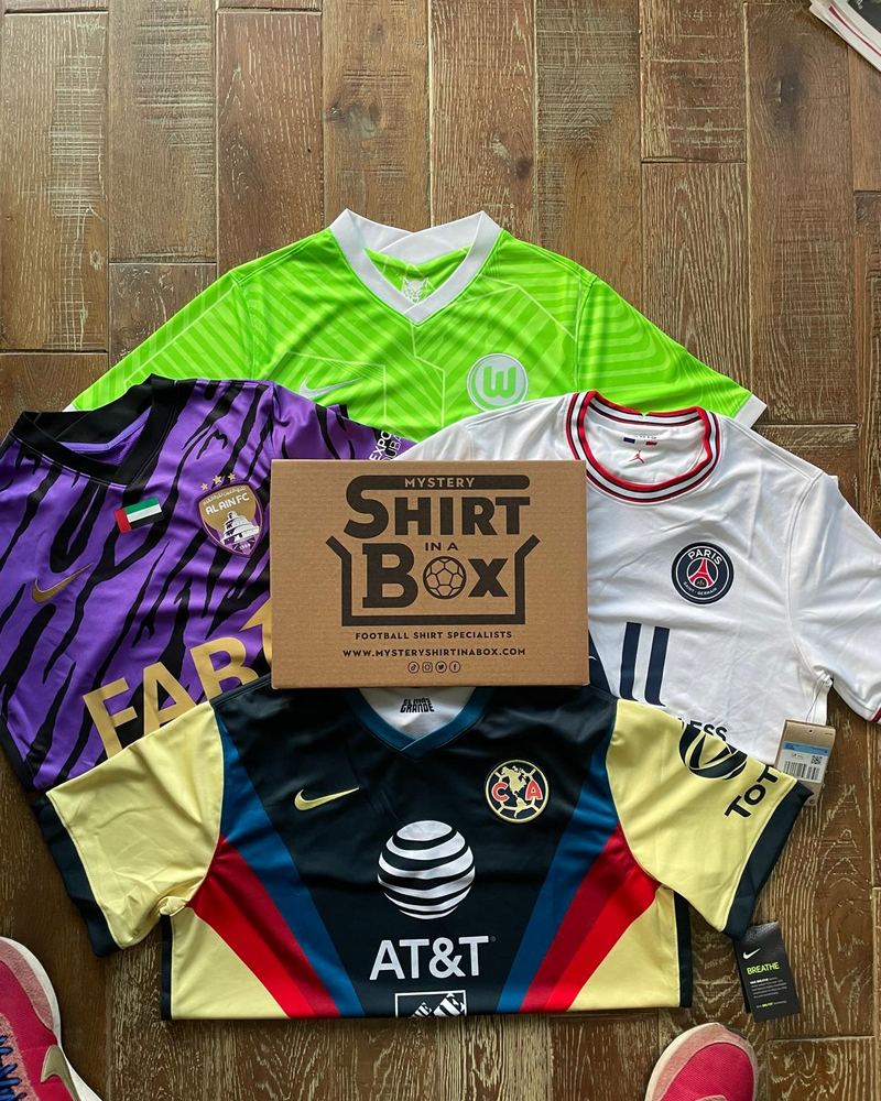Shirts laid out around a Shirt in a Box box