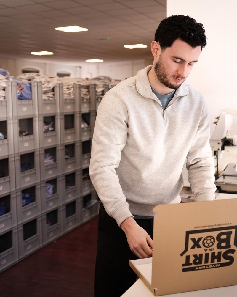 Rory packing a Shirt in a Box order in the warehouse